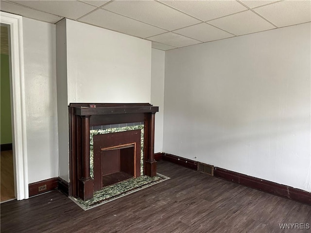 64 Barton St, Buffalo, NY 14213 - unfurnished living room with baseboards, wood finished floors, a paneled ceiling, and a tile fireplace