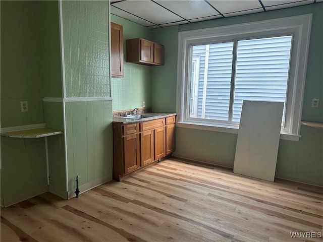 64 Barton St, Buffalo, NY 14213 - kitchen with a sink, light wood-style floors, and brown cabinetry