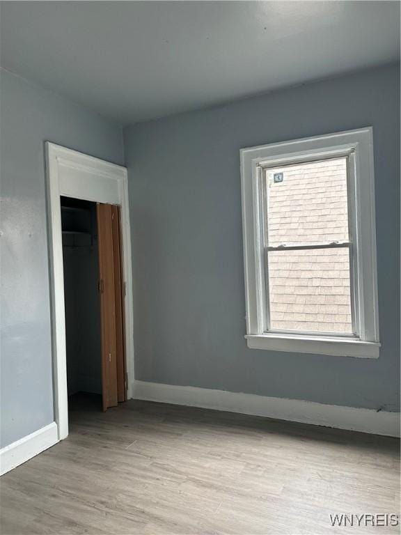 64 Barton St, Buffalo, NY 14213 - spare room with wood finished floors and baseboards
