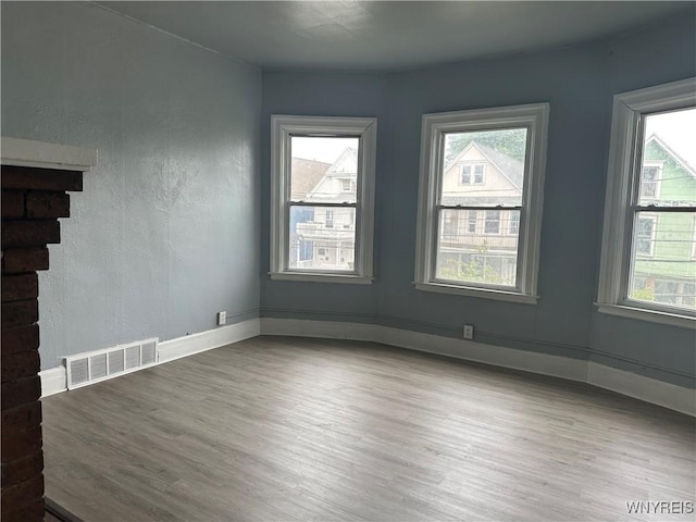 64 Barton St, Buffalo, NY 14213 - unfurnished living room featuring healthy amount of natural light, wood finished floors, and baseboards