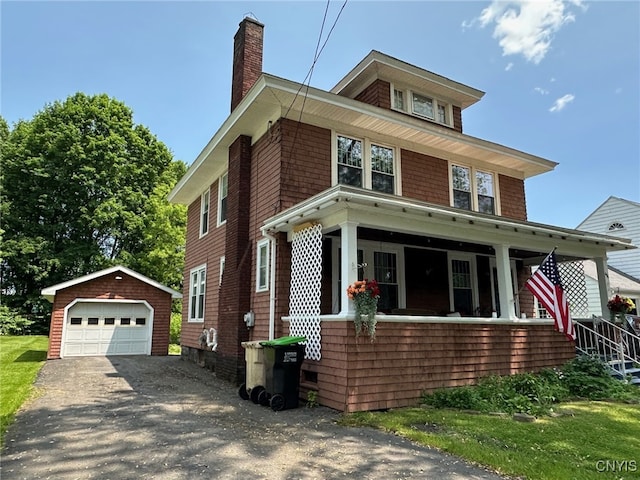 616 N Main St, Herkimer, NY 13350 - traditional style home with an outdoor structure, a chimney, covered porch, a detached garage, and asphalt driveway