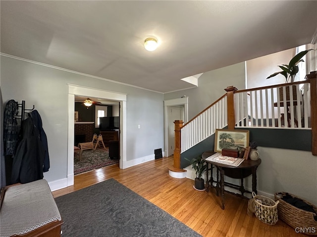 616 N Main St, Herkimer, NY 13350 - foyer entrance with wood finished floors, ceiling fan, stairs, ornamental molding, and baseboards