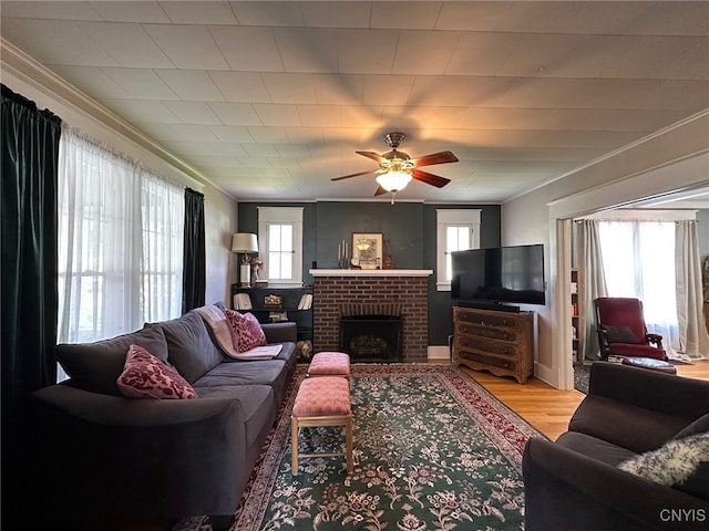 616 N Main St, Herkimer, NY 13350 - living area with plenty of natural light, crown molding, wood finished floors, a ceiling fan, and a brick fireplace