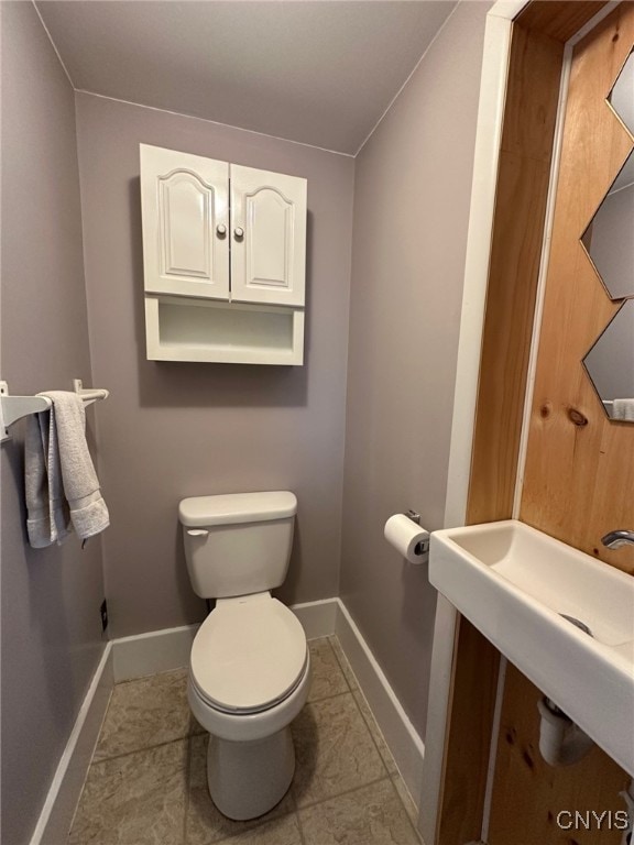 616 N Main St, Herkimer, NY 13350 - bathroom with toilet, baseboards, and tile patterned flooring