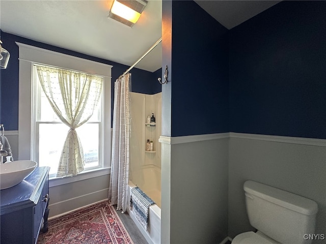 616 N Main St, Herkimer, NY 13350 - bathroom featuring shower / bath combination with curtain, toilet, vanity, wood finished floors, and baseboards