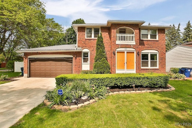 305 Vine Ln, Amherst, NY 14228 - view of front of house featuring an attached garage, concrete driveway, brick siding, and a front lawn