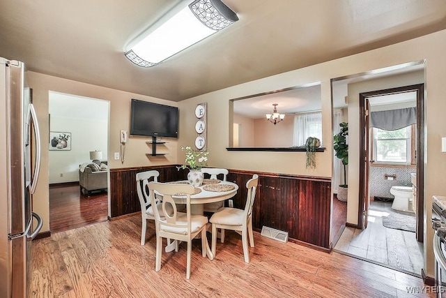 305 Vine Ln, Amherst, NY 14228 - dining area with light wood-style flooring and a chandelier