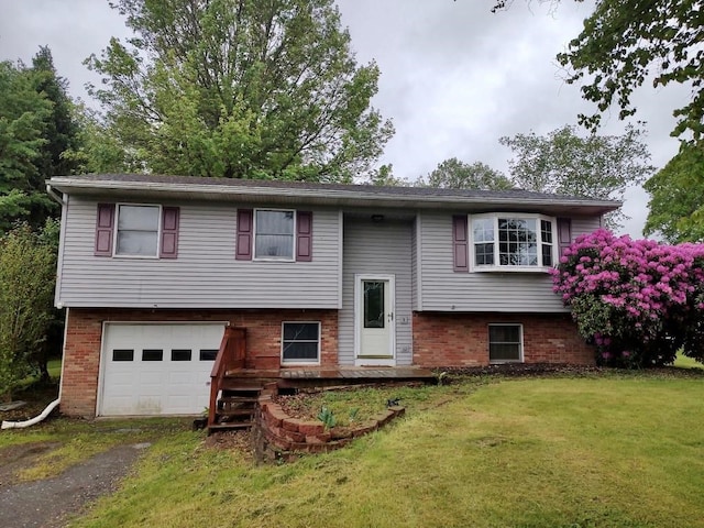 17 Ryon Cir, undefined, PA 16929 - raised ranch with a garage, driveway, brick siding, and a front yard