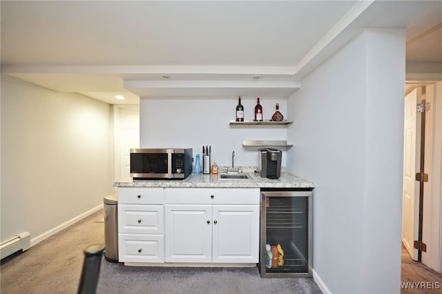 283 Summit Ave, West Seneca, NY 14224 - indoor wet bar with stainless steel microwave, beverage cooler, baseboard heating, light colored carpet, and baseboards