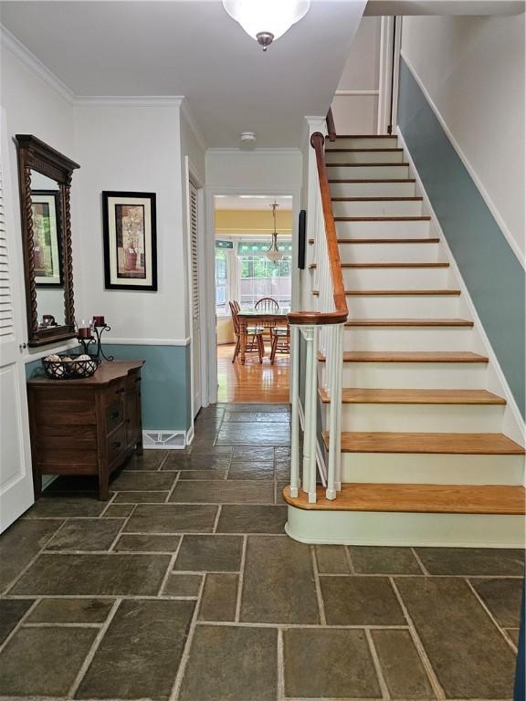 52 Woodland Dr, Big Flats, NY 14814 - stairway with stone tile floors, ornamental molding, and baseboards