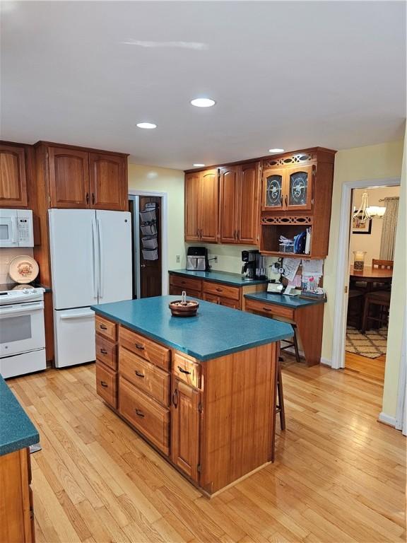 52 Woodland Dr, Big Flats, NY 14814 - kitchen featuring white appliances, dark countertops, light wood finished floors, brown cabinetry, and recessed lighting