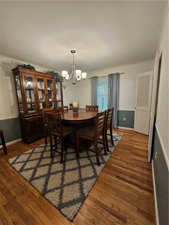 52 Woodland Dr, Big Flats, NY 14814 - dining space with a chandelier, wood finished floors, ornamental molding, and baseboards