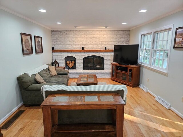 52 Woodland Dr, Big Flats, NY 14814 - living area featuring crown molding, light wood-style flooring, a brick fireplace, baseboards, and recessed lighting