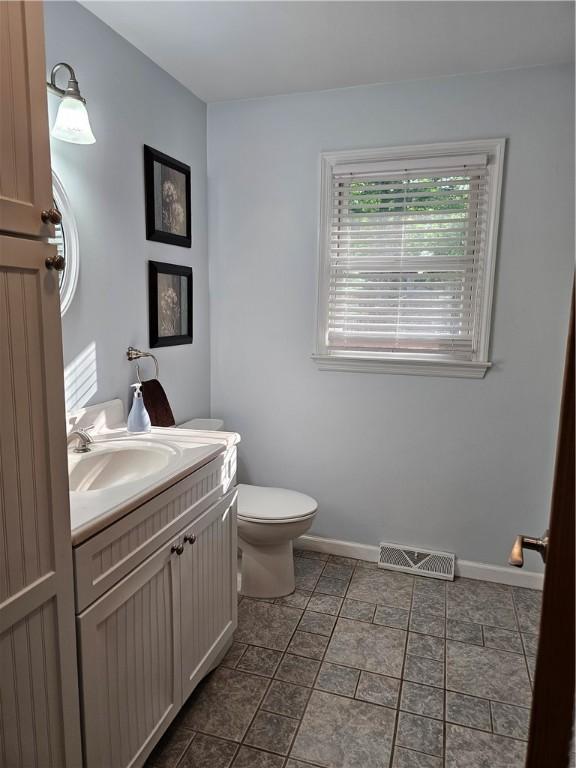 52 Woodland Dr, Big Flats, NY 14814 - bathroom with vanity, toilet, and baseboards
