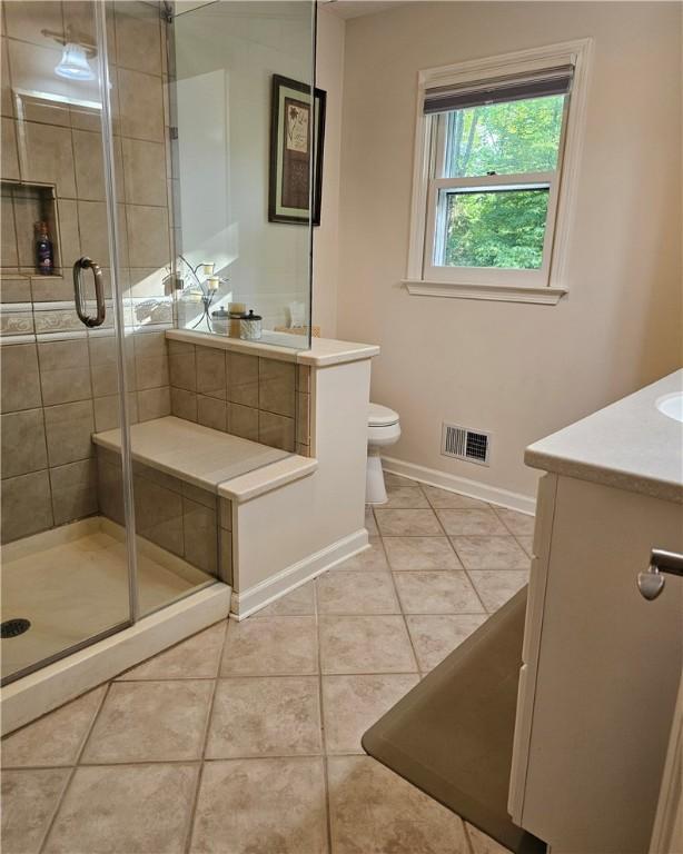 52 Woodland Dr, Big Flats, NY 14814 - full bath featuring vanity, toilet, tile patterned floors, baseboards, and a stall shower