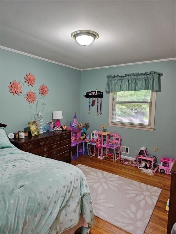 52 Woodland Dr, Big Flats, NY 14814 - bedroom featuring ornamental molding and wood finished floors