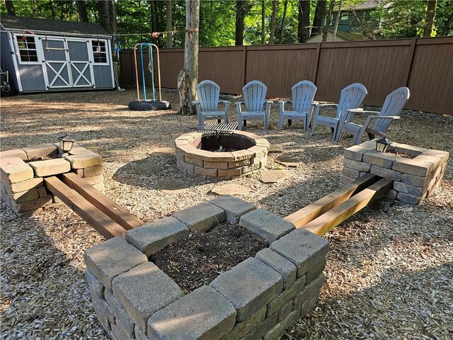 52 Woodland Dr, Big Flats, NY 14814 - fenced backyard featuring an outdoor fire pit