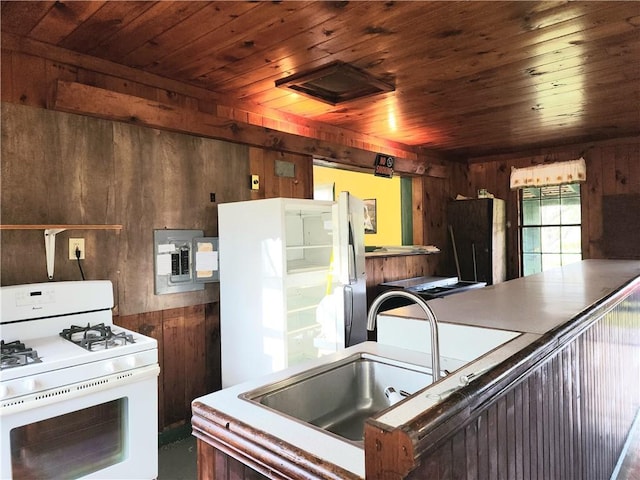 655 County Highway 26, Otsego, NY 13337 - kitchen with white appliances, wood walls, wooden ceiling, and a sink