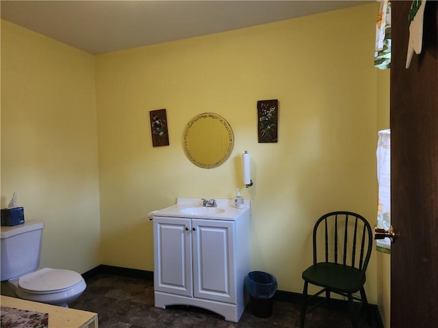 655 County Highway 26, Otsego, NY 13337 - bathroom featuring toilet, vanity, baseboards, and stone finish floors