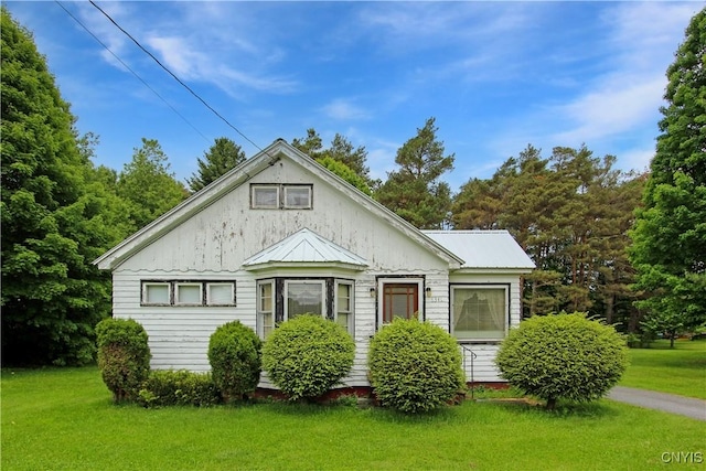 6341 Number Four Rd, Watson, NY 13367 - bungalow-style house featuring a front lawn and metal roof