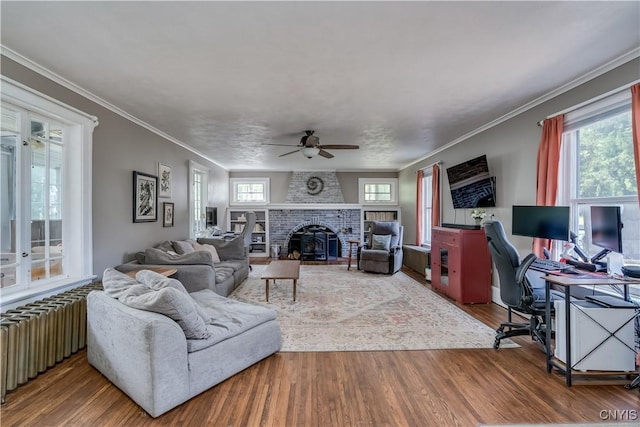 621 N Hycliff Dr, Watertown-City, NY 13601 - living area with radiator, ceiling fan, an office area, wood finished floors, and crown molding