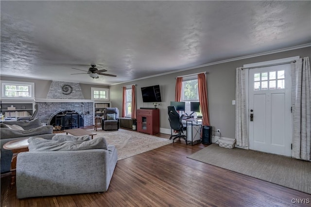621 N Hycliff Dr, Watertown-City, NY 13601 - living area featuring wood finished floors, healthy amount of natural light, ceiling fan, a brick fireplace, and crown molding