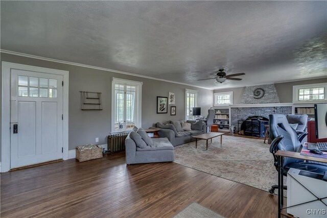 621 N Hycliff Dr, Watertown-City, NY 13601 - living area with dark wood finished floors, healthy amount of natural light, radiator heating unit, ceiling fan, and ornamental molding