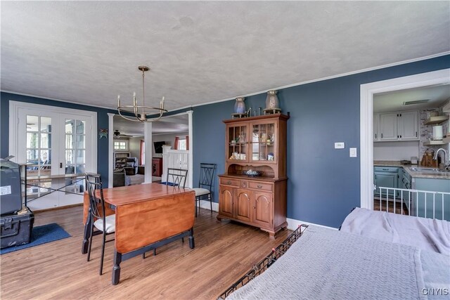 621 N Hycliff Dr, Watertown-City, NY 13601 - dining space featuring light wood finished floors, ornamental molding, baseboards, and french doors
