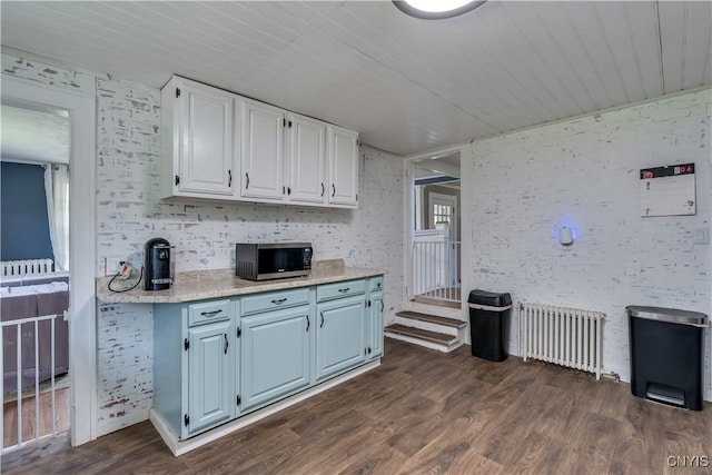 621 N Hycliff Dr, Watertown-City, NY 13601 - kitchen featuring stainless steel microwave, radiator, white cabinets, dark wood-style floors, and wooden ceiling