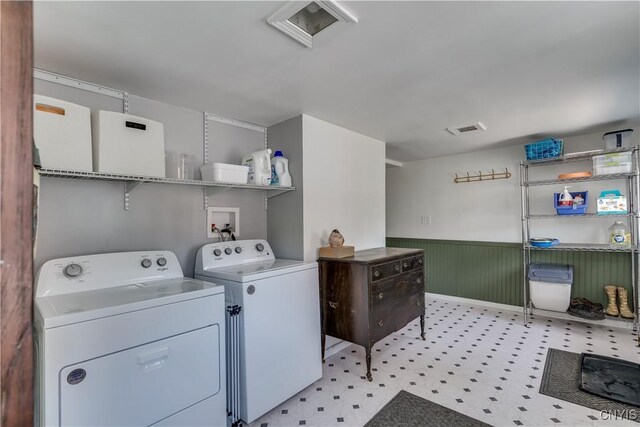 621 N Hycliff Dr, Watertown-City, NY 13601 - laundry area featuring washing machine and clothes dryer, a wainscoted wall, and light flooring