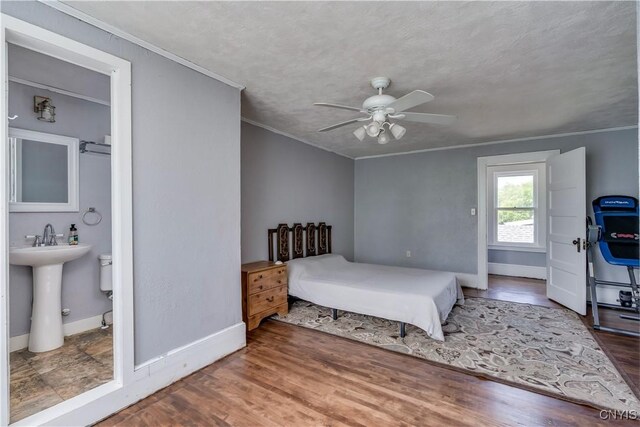 621 N Hycliff Dr, Watertown-City, NY 13601 - bedroom featuring crown molding, wood finished floors, baseboards, a sink, and ceiling fan