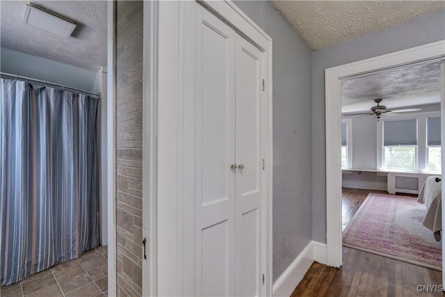 621 N Hycliff Dr, Watertown-City, NY 13601 - hallway featuring a textured ceiling, baseboards, and wood finished floors