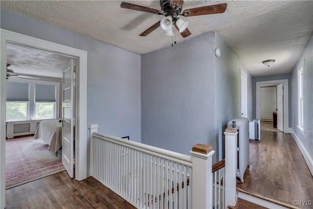 621 N Hycliff Dr, Watertown-City, NY 13601 - hallway featuring an upstairs landing, wood finished floors, a textured ceiling, and plenty of natural light
