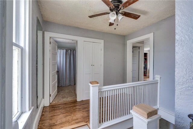 621 N Hycliff Dr, Watertown-City, NY 13601 - hall with a textured ceiling, wood finished floors, and an upstairs landing