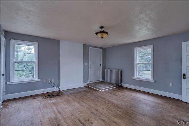 621 N Hycliff Dr, Watertown-City, NY 13601 - entryway featuring radiator heating unit, baseboards, and wood finished floors