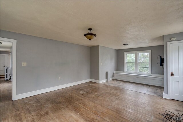 621 N Hycliff Dr, Watertown-City, NY 13601 - unfurnished living room with wood finished floors and baseboards