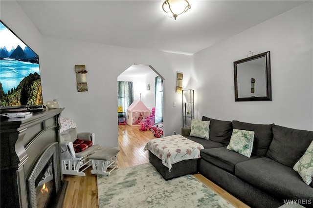 283 W Tupper St, Buffalo, NY 14201 - living room with wood finished floors, arched walkways, and healthy amount of natural light