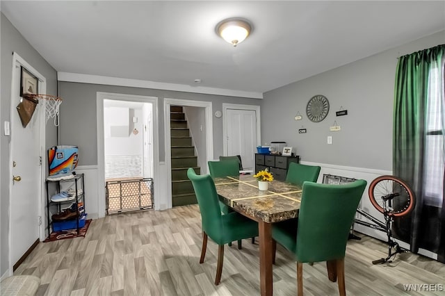 283 W Tupper St, Buffalo, NY 14201 - dining room with stairway, light wood-style flooring, wainscoting, and baseboard heating