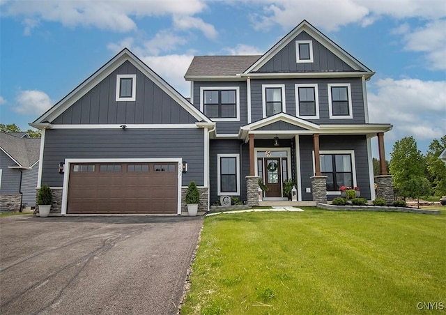 8033 Forest Ridge Ln, Lysander, NY 13027 - craftsman house with board and batten siding, stone siding, a front yard, driveway, and a garage