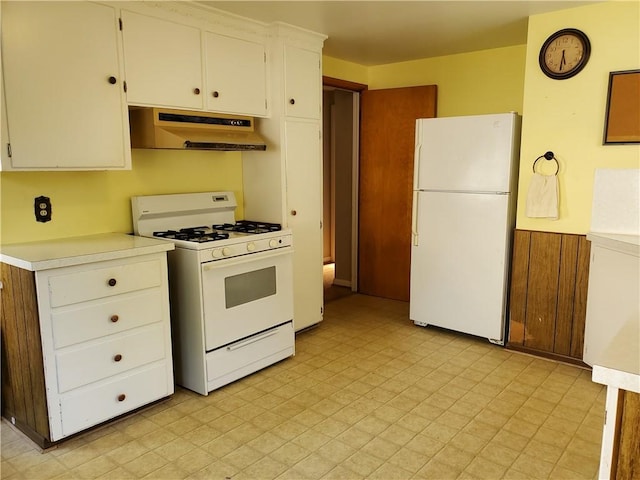 526 Winchester St, Rochester, NY 14615 - kitchen featuring white appliances, under cabinet range hood, wainscoting, light countertops, and white cabinets