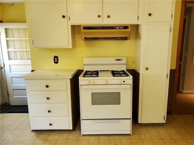 526 Winchester St, Rochester, NY 14615 - kitchen with white range with gas stovetop, extractor fan, light countertops, and white cabinetry