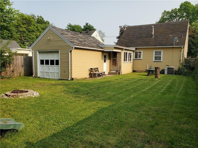 526 Winchester St, Rochester, NY 14615 - rear view of house with a fire pit, central air condition unit, and a garage