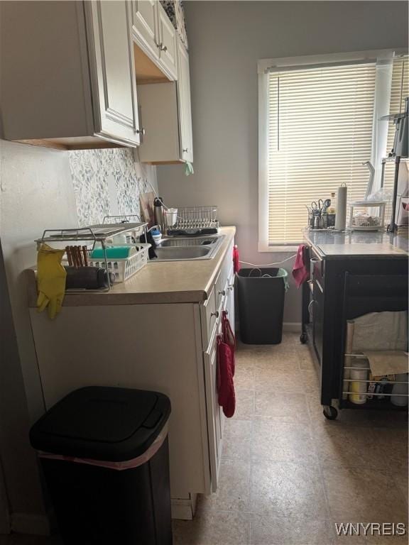 44 Freeman St, Buffalo, NY 14215 - kitchen featuring white cabinetry, a sink, and light countertops