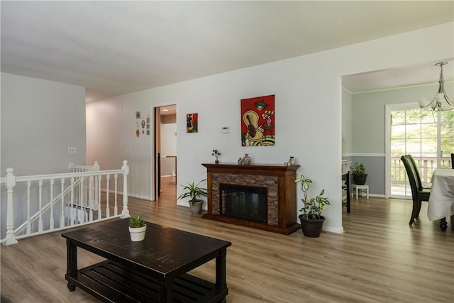 25 Highland Dr, Corning-City, NY 14830 - living area with wood finished floors, a chandelier, baseboards, and a glass covered fireplace