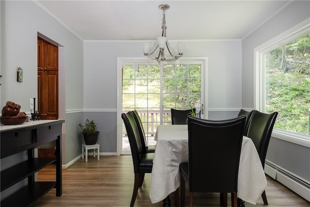 25 Highland Dr, Corning-City, NY 14830 - dining room featuring a baseboard radiator, a chandelier, plenty of natural light, ornamental molding, and wood finished floors