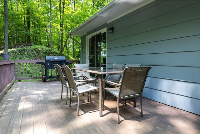 25 Highland Dr, Corning-City, NY 14830 - deck featuring outdoor dining space, grilling area, and a view of trees