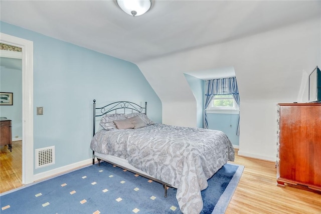 350 Colebourne Rd, Rochester, NY 14609 - bedroom featuring wood finished floors, lofted ceiling, and baseboards