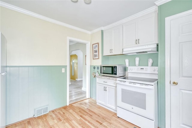 350 Colebourne Rd, Rochester, NY 14609 - kitchen with white electric stove, under cabinet range hood, stainless steel microwave, arched walkways, and white cabinetry