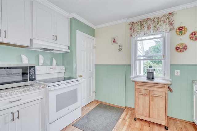 350 Colebourne Rd, Rochester, NY 14609 - kitchen featuring white range with electric cooktop, under cabinet range hood, stainless steel microwave, light countertops, and wainscoting