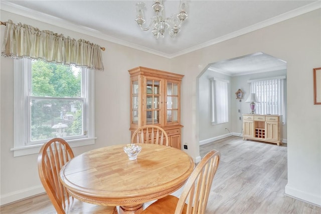 350 Colebourne Rd, Rochester, NY 14609 - dining space featuring arched walkways, a chandelier, plenty of natural light, light wood-style floors, and ornamental molding